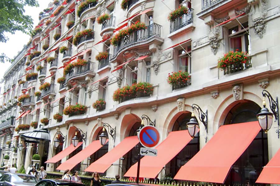 Grande façade haussmannienne parisienne restaurée avec marquises et persiennes